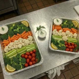 Vegetable platter catering trays with broccoli, carrots, cauliflower, celery, cherry tomatoes, and ranch dip at Ally’s Comfort Café in Davie, FL